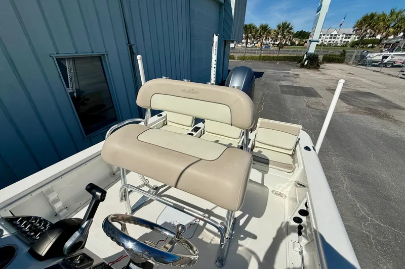 Slide: The Image of 2017 NauticStar 227 XTS boat interior with beige seating and steering wheel. - 7