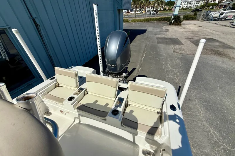 Slide: The Image of 2017 NauticStar 227 XTS boat with seating and outboard motor in a marina setting. - 8
