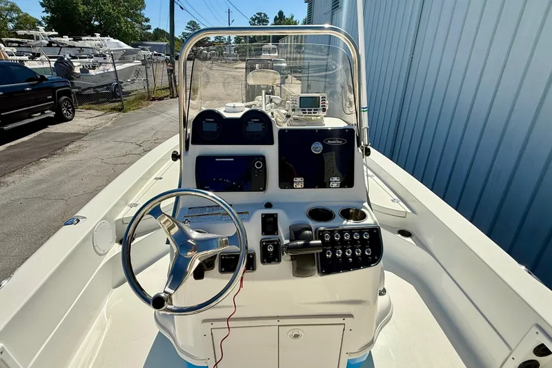 Slide: The Image of 2017 NauticStar 227 XTS boat dashboard with steering wheel and control panel. - 9