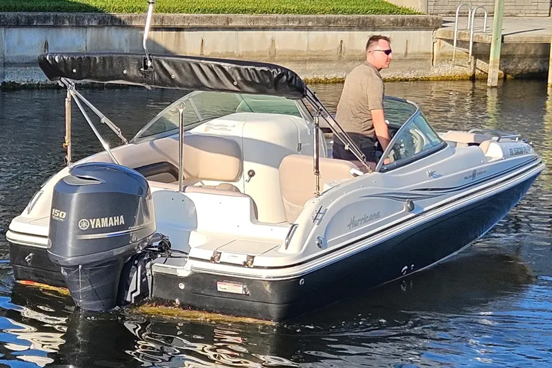 Slide: The Image of 2013 Hurricane SunDeck 217 OB boat with Yamaha engine on calm water. - 6