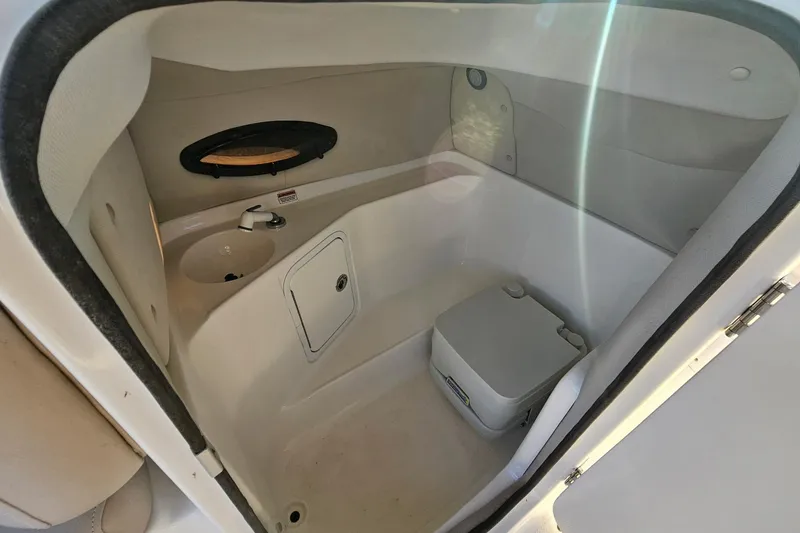Slide: The Image of Interior of 2013 Hurricane SunDeck 217 OB boat with compact bathroom amenities. - 9