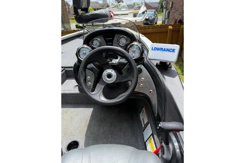 Slide: The Image of 2024 Bass Tracker Pro 17 boat dashboard with steering wheel and Lowrance display. - 10