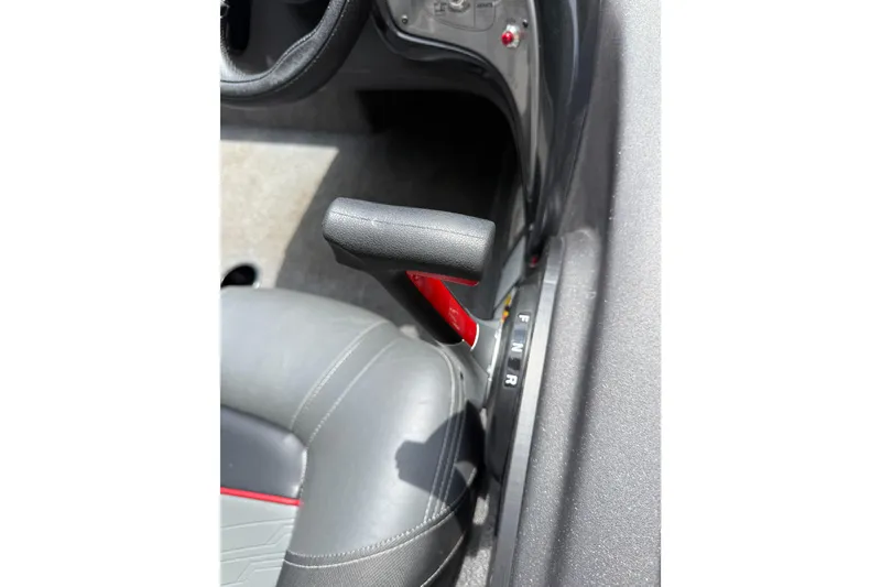 Slide: The Image of 2024 Bass Tracker Pro 17 boat interior with gear shift lever and seat detail. - 8