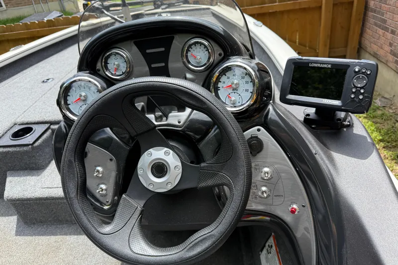 Slide: The Image of 2024 Bass Tracker Pro 17 dashboard with steering wheel, gauges, and Lowrance fish finder. - 9