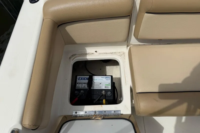 Slide: The Image of 2017 Scout 210 Dorado boat battery compartment with Exide battery visible. - 10