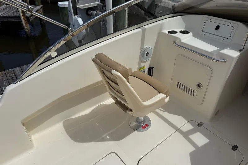 Slide: The Image of 2017 Scout 210 Dorado boat interior with swivel seat and cup holders. - 16