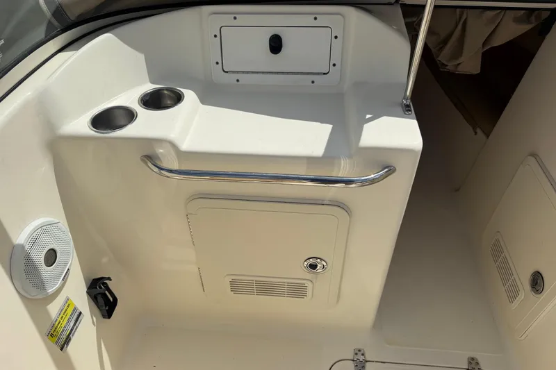 Slide: The Image of Interior of 2017 Scout 210 Dorado boat with cup holders and storage compartments. - 18