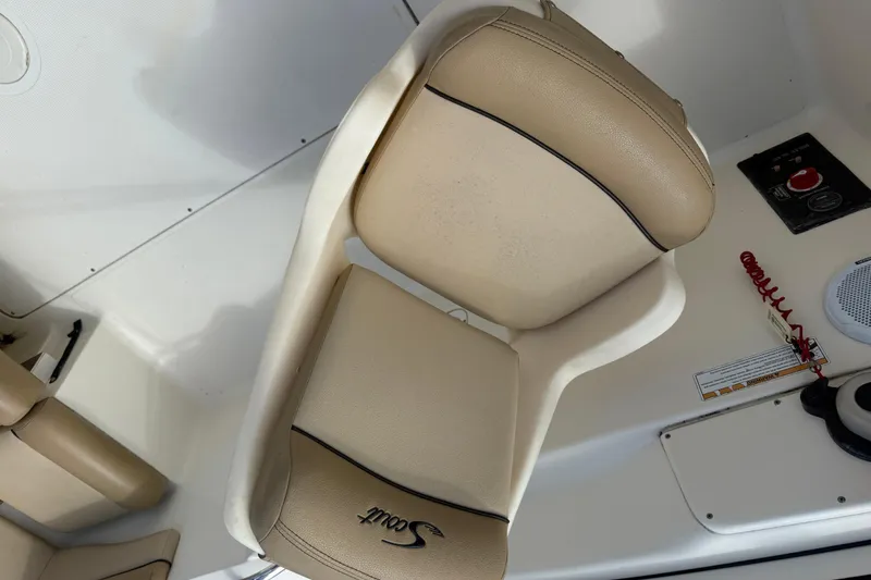 Slide: The Image of Interior of a 2017 Scout 210 Dorado boat with beige seating. - 21