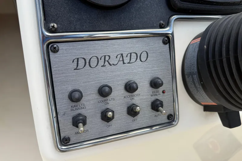 Slide: The Image of Control panel of 2017 Scout 210 Dorado boat with switches and labels. - 25