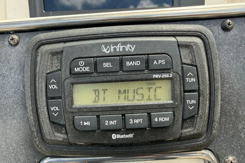 Slide: The Image of Infinity PRV-250.2 stereo displaying "BT MUSIC" on a 2017 Scout 210 Dorado boat. - 28