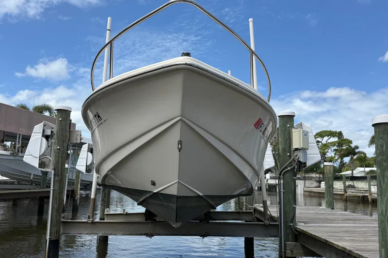 Slide: The Image of 2017 Scout 210 Dorado boat docked, viewed from the front, under a clear blue sky. - 3