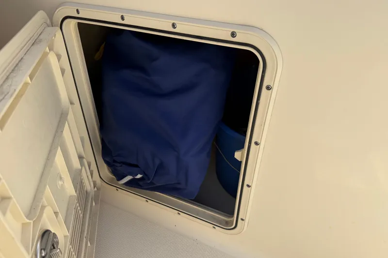 Slide: The Image of Storage compartment on a 2017 Scout 210 Dorado boat with blue bag inside. - 33
