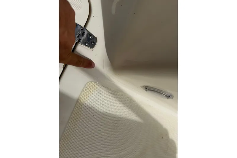 Slide: The Image of Close-up of a 2017 Scout 210 Dorado boat interior detail with finger pointing. - 35