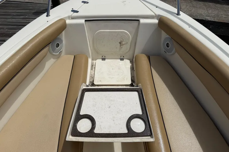 Slide: The Image of Interior view of a 2017 Scout 210 Dorado boat with tan seating and storage compartment. - 38