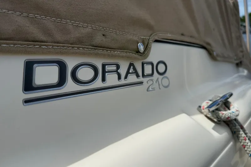 Slide: The Image of 2017 Scout 210 Dorado boat logo with canvas cover and rope detail. - 5