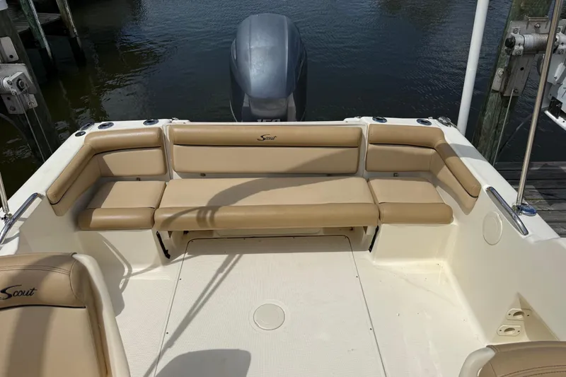 Slide: The Image of 2017 Scout 210 Dorado boat with beige seating and outboard motor at dock. - 7
