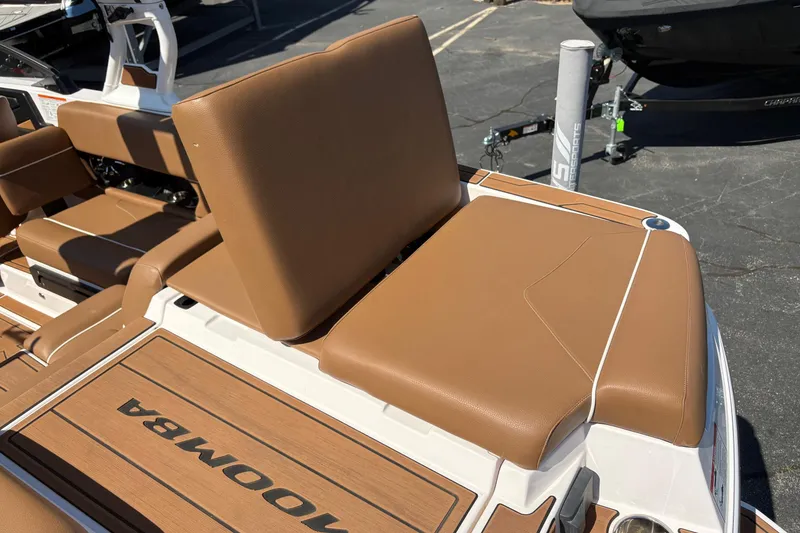 Slide: The Image of 2023 Moomba Kaiyen boat interior with brown seating and deck. - 14