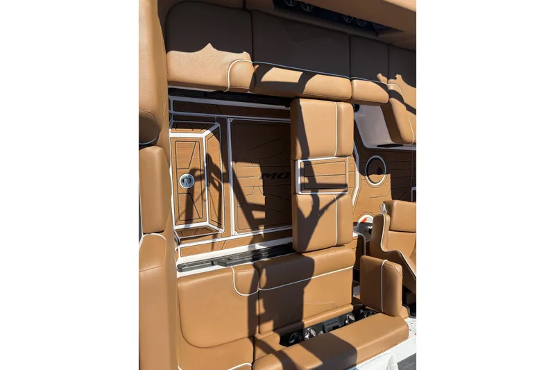 Slide: The Image of 2023 Moomba Kaiyen boat interior with tan leather seating and sleek design. - 17