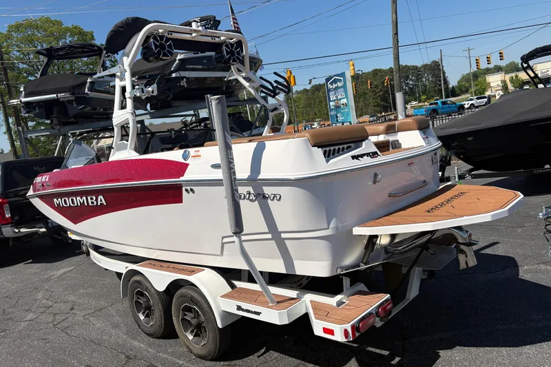 Slide: The Image of 2023 Moomba Kaiyen boat on trailer, featuring sleek design and vibrant red accents. - 3