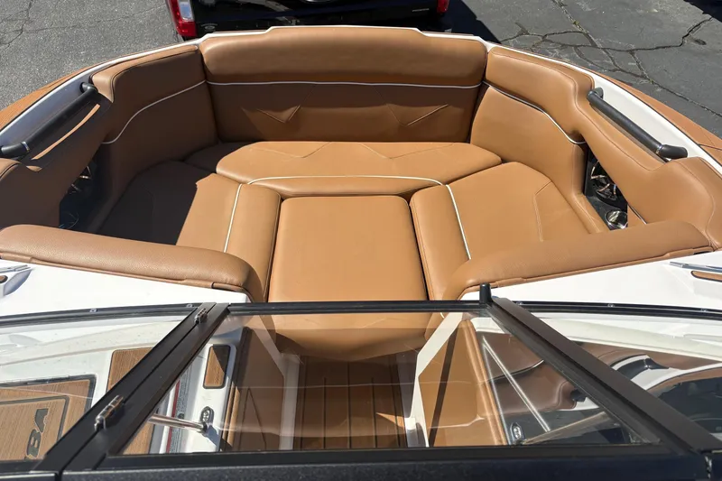 Slide: The Image of 2023 Moomba Kaiyen boat interior with tan leather seating and sleek design. - 9