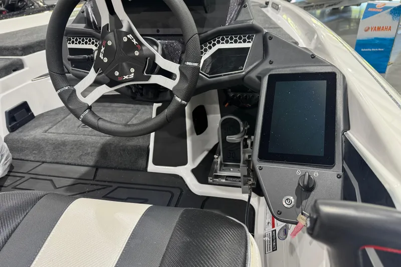 Slide: The Image of Interior of 2026 Skeeter FXR21 FLEX boat featuring steering wheel and digital display. - 10