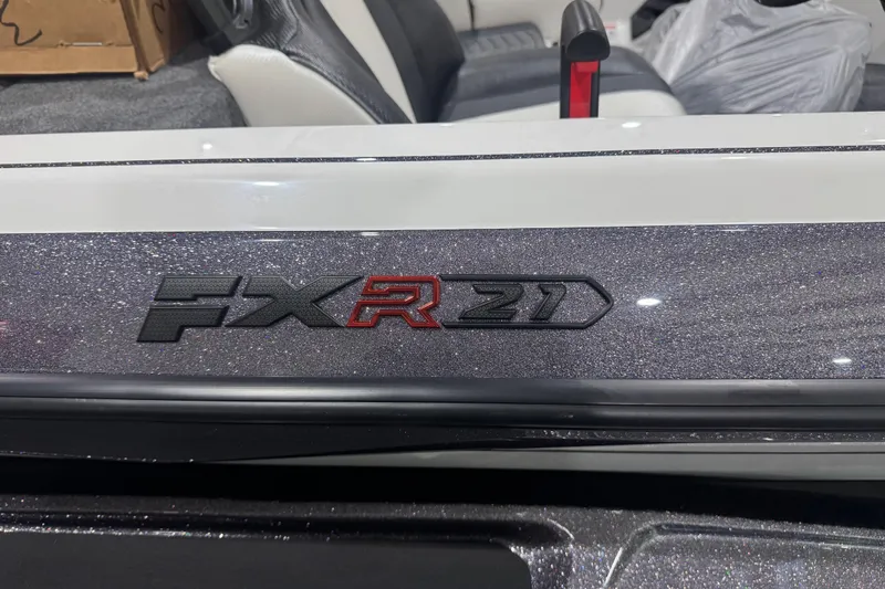 Slide: The Image of 2026 Skeeter FXR21 FLEX boat logo on a glittery surface. - 2