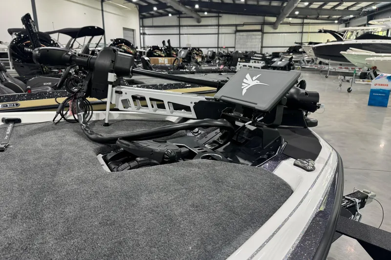 Slide: The Image of 2026 Skeeter FXR21 FLEX boat with advanced trolling motor in a showroom. - 3