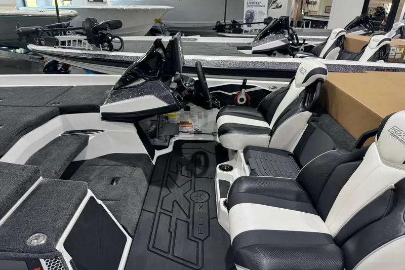 Slide: The Image of 2026 Skeeter FXR21 FLEX boat interior with sleek black and white seating and modern dashboard. - 7