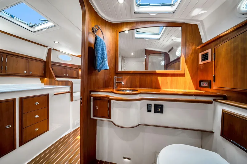 Slide: The Image of Luxurious interior of 2020 Hinckley Picnic Boat 40 with elegant wood finish and modern amenities. - 13