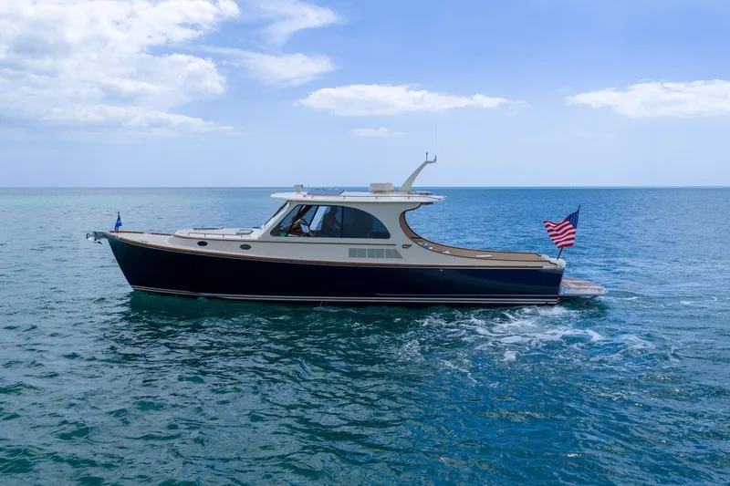 Slide: The Image of 2020 Hinckley Picnic Boat 40 cruising on open sea under blue sky. - 3