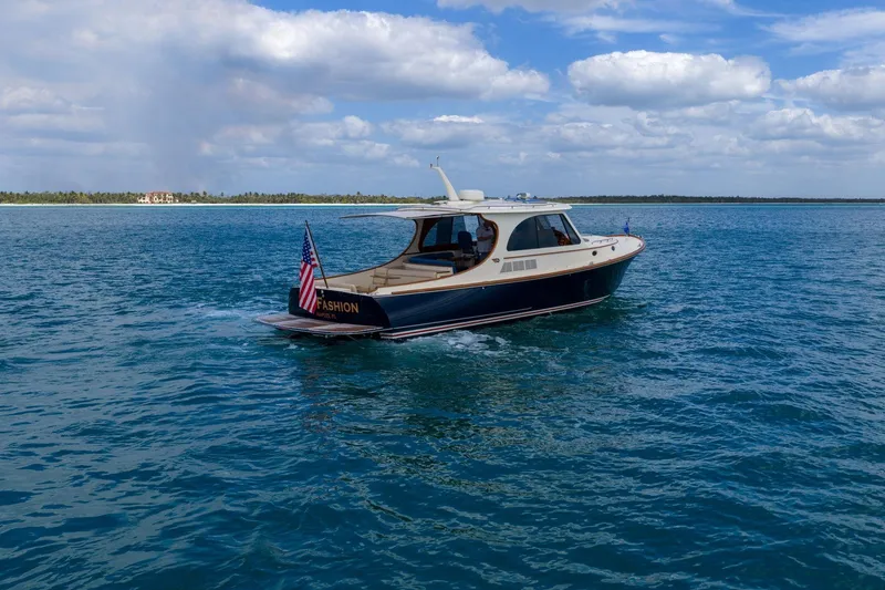 Slide: The Image of 2020 Hinckley Picnic Boat 40 cruising on open water under a partly cloudy sky. - 4