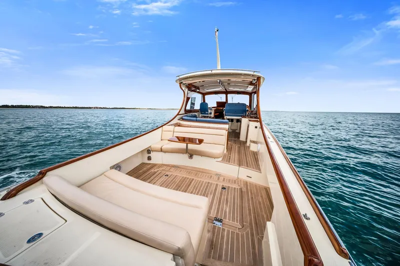 Slide: The Image of 2020 Hinckley Picnic Boat 40 cruising on open water under a clear blue sky. - 5