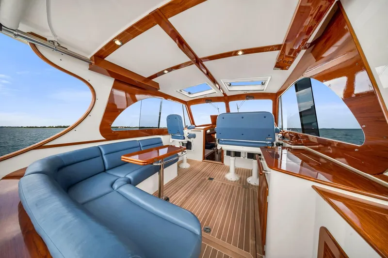 Slide: The Image of Luxurious 2020 Hinckley Picnic Boat 40 interior with elegant wood and blue seating. - 6