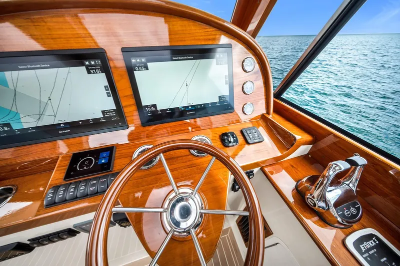 Slide: The Image of 2020 Hinckley Picnic Boat 40 helm with dual Garmin displays and wooden steering wheel. - 8
