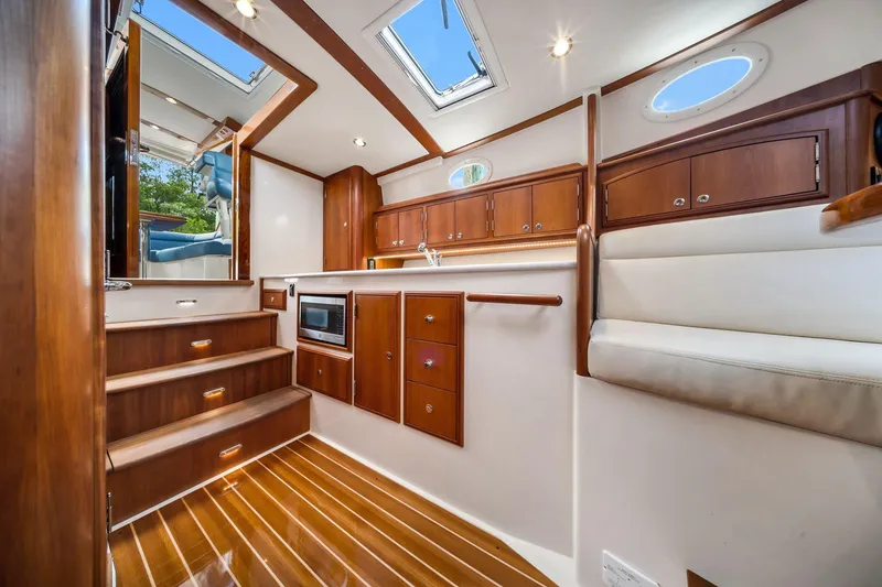 Slide: The Image of Interior of 2020 Hinckley Picnic Boat 40 with elegant wood finish and modern amenities. - 9
