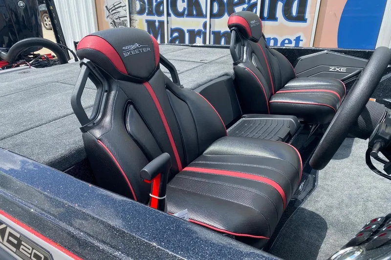 Slide: The Image of 2026 Skeeter ZXE20 boat interior with black and red seats, showcasing sleek design. - 11