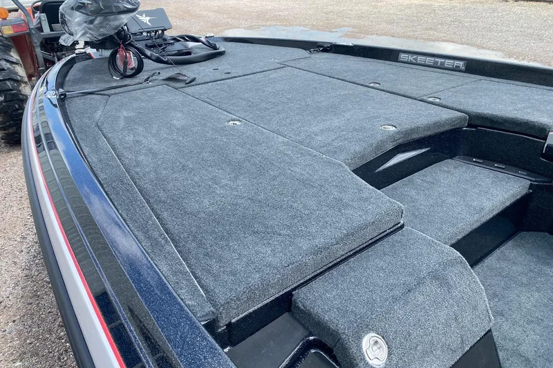 Slide: The Image of 2026 Skeeter ZXE20 boat deck with carpeted surface and storage compartments. - 13