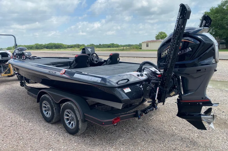 Slide: The Image of 2026 Skeeter ZXE20 boat with Yamaha engine on a trailer, parked outdoors. - 7