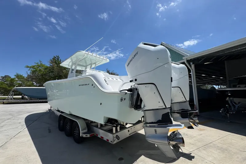 Slide: The Image of 2024 Invincible 33 Catamaran with dual Mercury outboard engines on a trailer. - 16