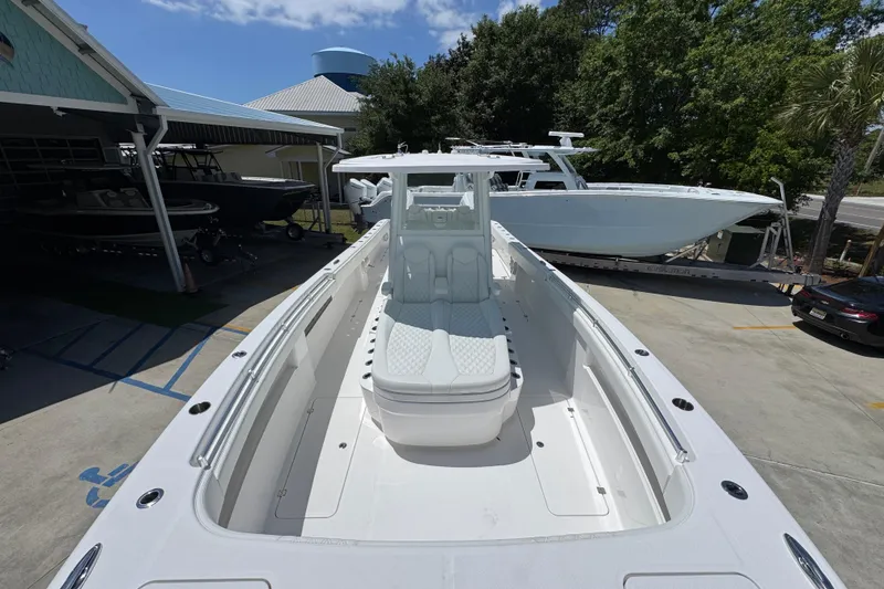 Slide: The Image of 2024 Invincible 33 Catamaran docked, showcasing spacious deck and sleek design. - 18