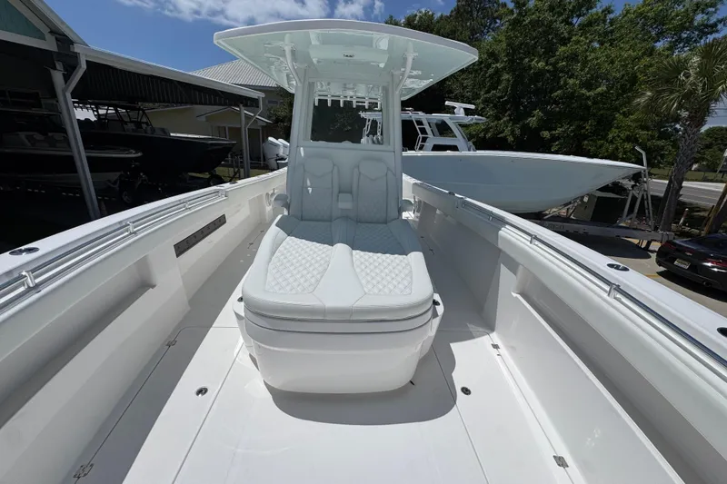 Slide: The Image of 2024 Invincible 33 Catamaran with sleek white seating and modern design. - 19