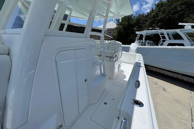 Slide: The Image of 2024 Invincible 33 Catamaran with sleek white interior and modern design features. - 23
