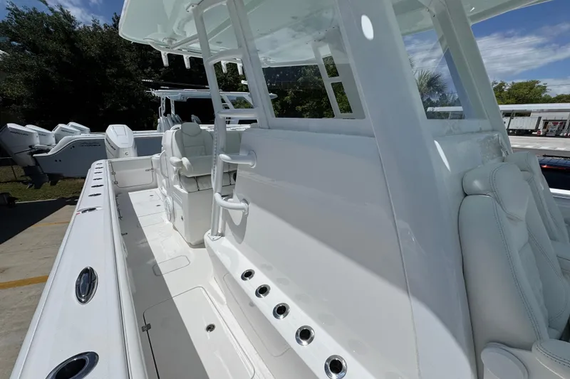 Slide: The Image of 2024 Invincible 33 Catamaran interior with sleek white seating and modern design. - 24