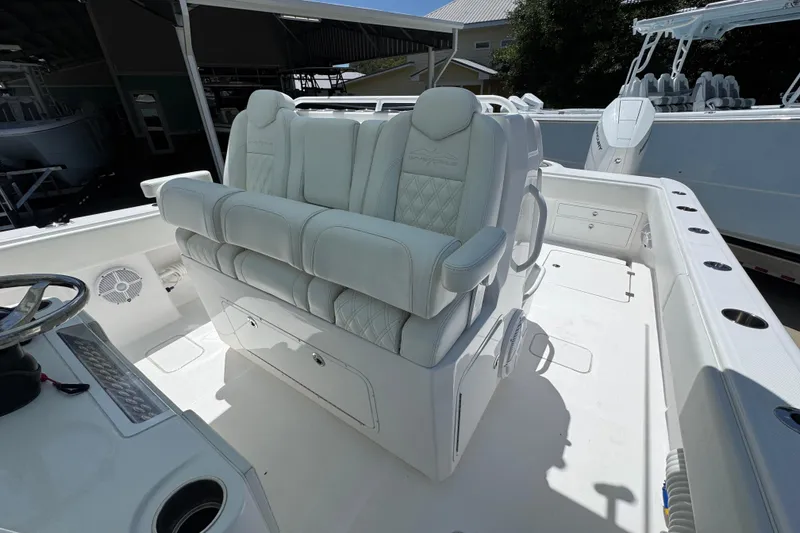 Slide: The Image of 2024 Invincible 33 Catamaran interior with luxurious white seating and modern helm. - 27