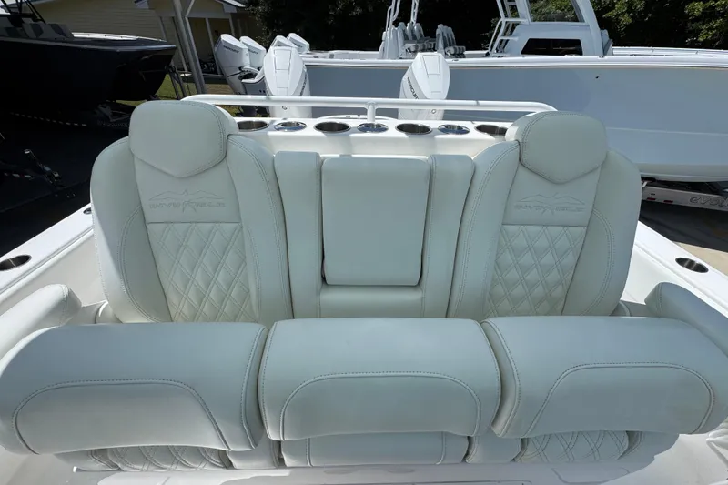 Slide: The Image of Luxurious seating on 2024 Invincible 33 Catamaran, featuring elegant diamond-stitched upholstery. - 28