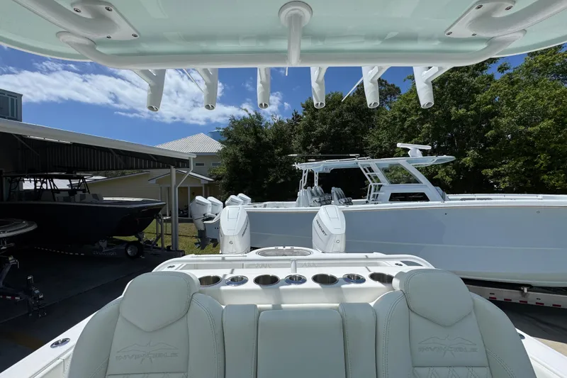 Slide: The Image of 2024 Invincible 33 Catamaran in marina, showcasing sleek design and powerful engines. - 29