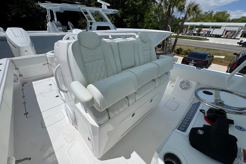 Slide: The Image of 2024 Invincible 33 Catamaran with luxurious white seating and modern helm controls. - 30