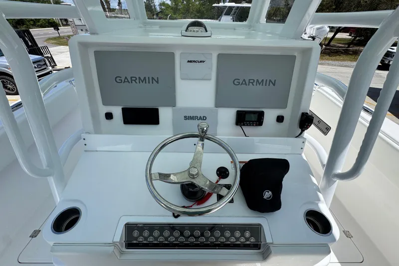 Slide: The Image of 2024 Invincible 33 Catamaran helm with Garmin displays and Simrad controls. - 32