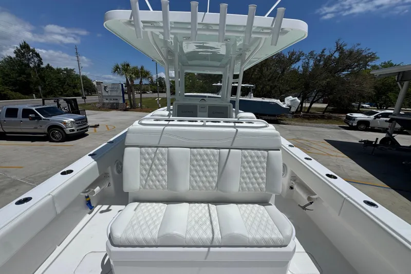 Slide: The Image of 2024 Invincible 33 Catamaran with luxurious seating and modern design in a parking area. - 36