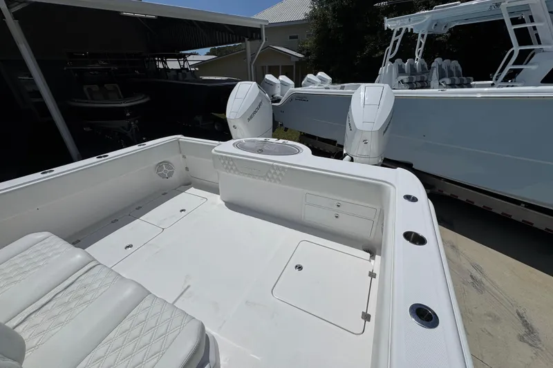 Slide: The Image of 2024 Invincible 33 Catamaran boat interior with seating and dual outboard motors. - 38